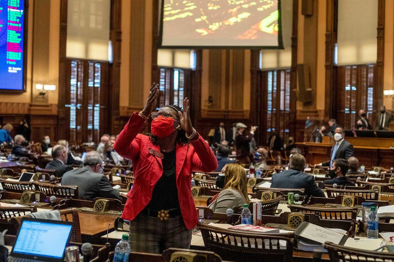 Rep. Park Cannon, D-Atlanta, applauds as Rep. Bee Nguyen, D-Atlanta, speaks in opposition of SB 202 in the House Chambers during a legislative session at the Georgia State Capitol Building in Atlanta, Thursday, March 25, 2021.