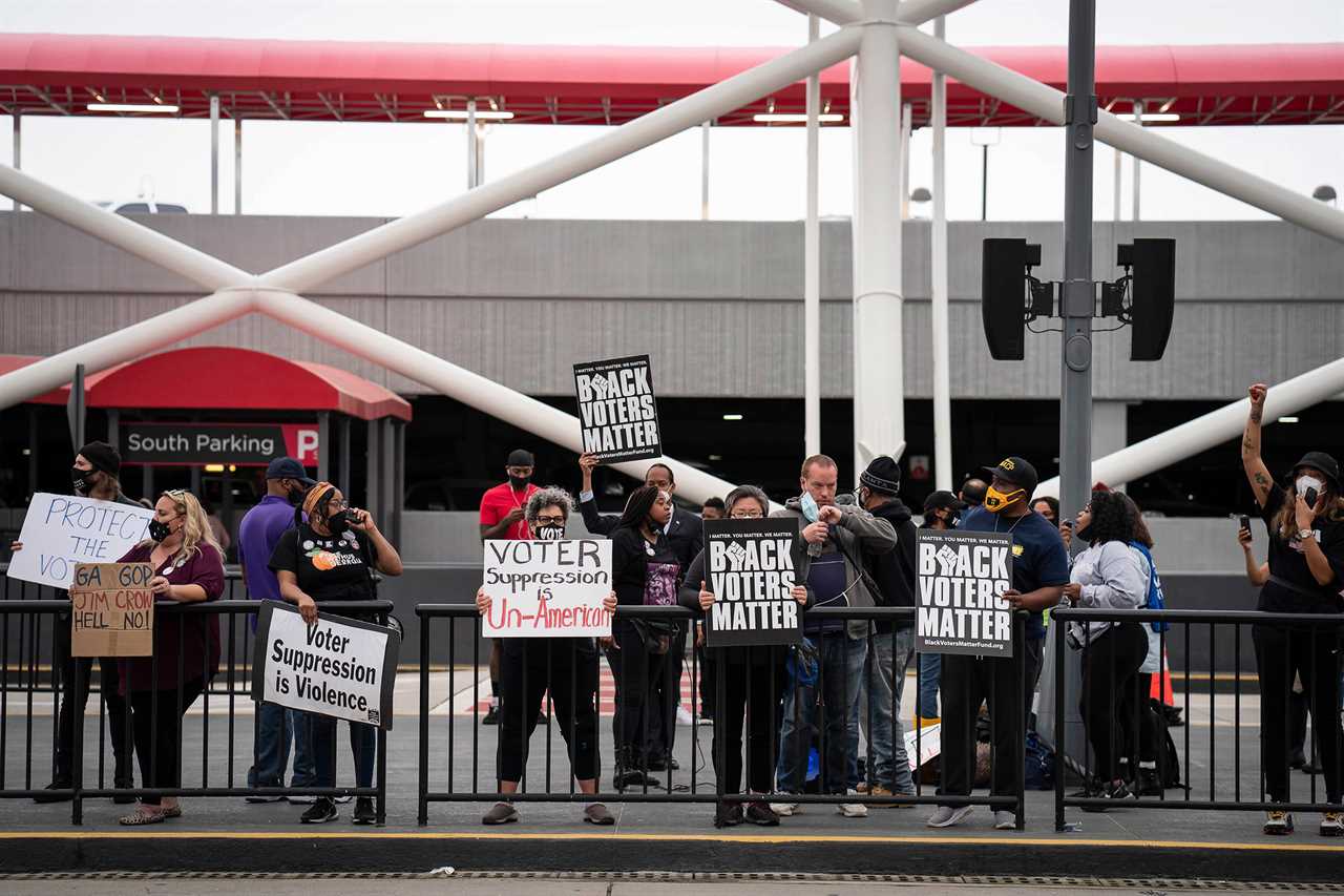 Voting-rights activists call for a boycott of Delta Air Lines during a protest at Hartsfield-Jackson Atlanta International Airport in Atlanta, March 25, 2021.