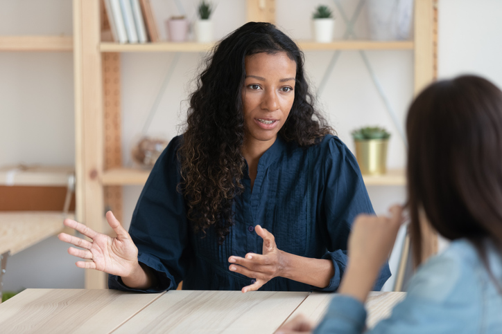 woman confidently setting better boundaries with her boss at work