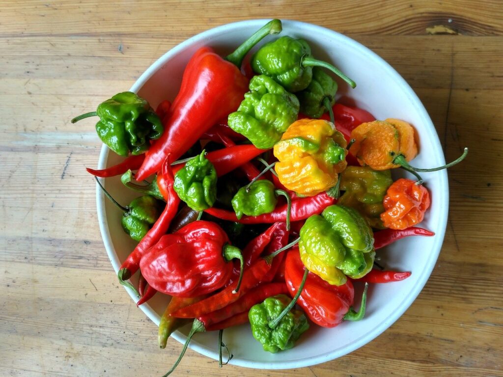 assorted hot peppers in a bowl including carolina reaper