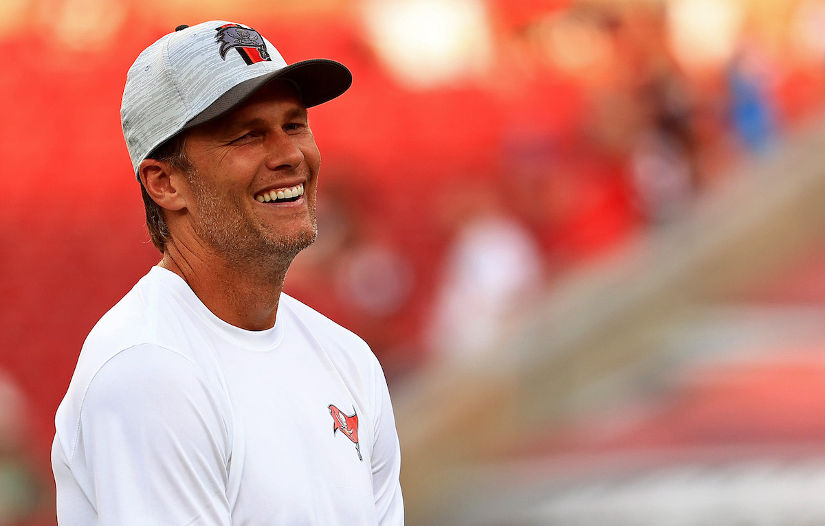 Tom Brady, #12 of the Tampa Bay Buccaneers, looks on during a preseason game against the Tennessee Titans at Raymond James Stadium on August 21, 2021, in Tampa, Florida