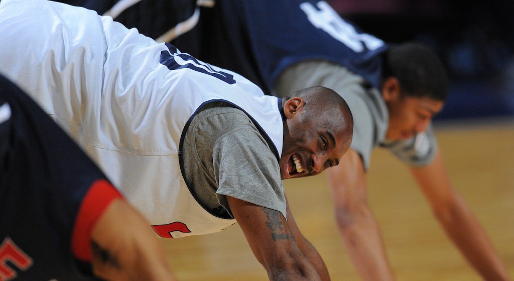 Kobe Bryant stretches during a training session with the Olympic basketball team