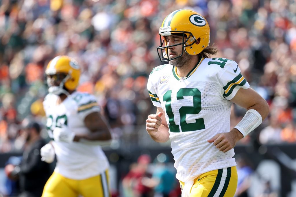 Aaron Rodgers runs onto the field