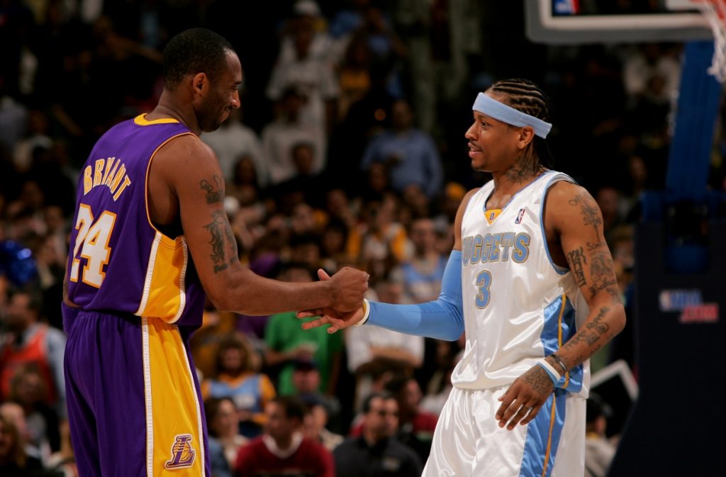 Kobe Bryant and Allen Iverson greet each other at half court.