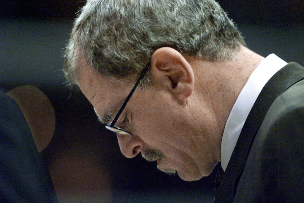 Former Los Angeles Lakers head coach Phil Jackson lowers his head during an NBA game against the Portland Trail Blazers in 2000