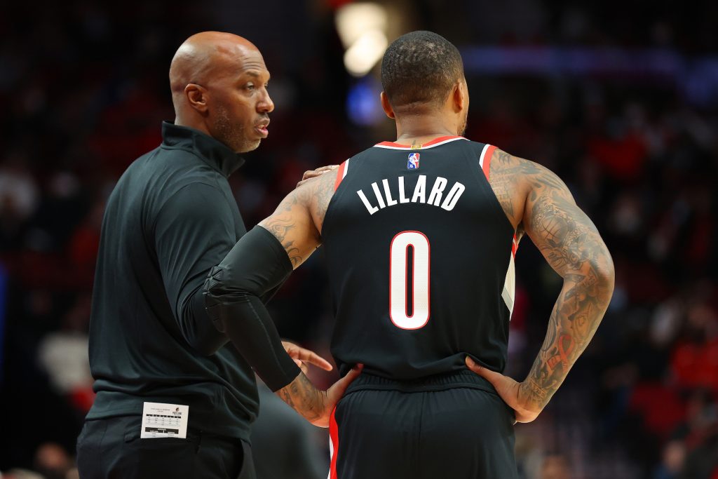 Portland Trail Blazers head coach Chauncey Billups speaks with point guard Damian Lillard during an NBA game in October