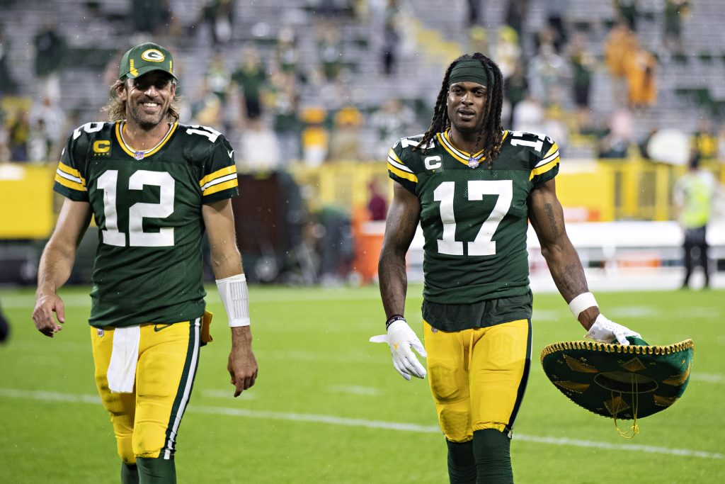 Packers teammates Davante Adams and Aaron Rodgers walk off the field after a game