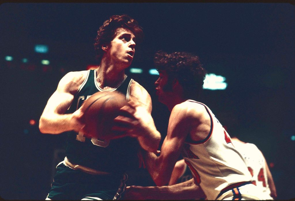 Boston Celtics center Dave Cowens shoots the ball during an NBA game in November 1973