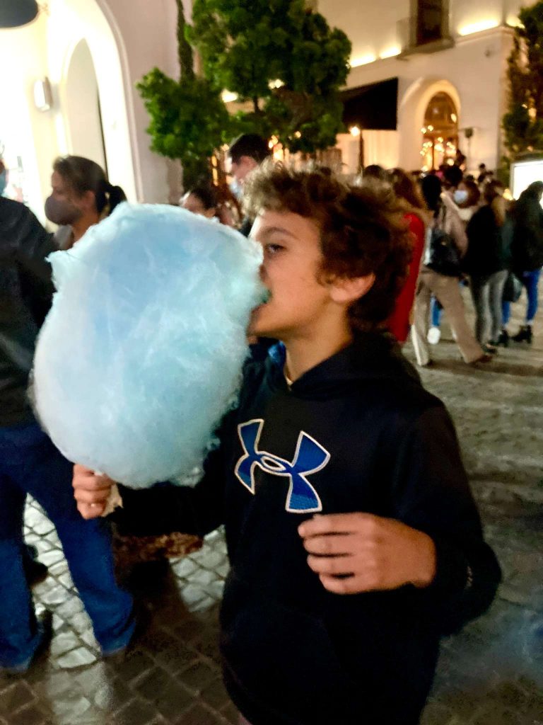 kid eating cottom candy at ciudad cayala in guatemala city