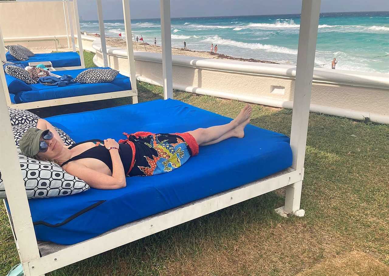 woman laying on a bech near the beach in cancun