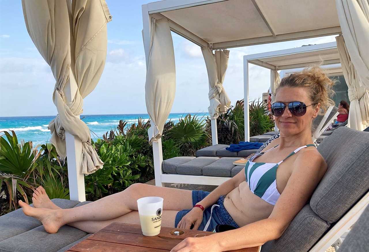 woman lying on a beach lounge chair in cancun