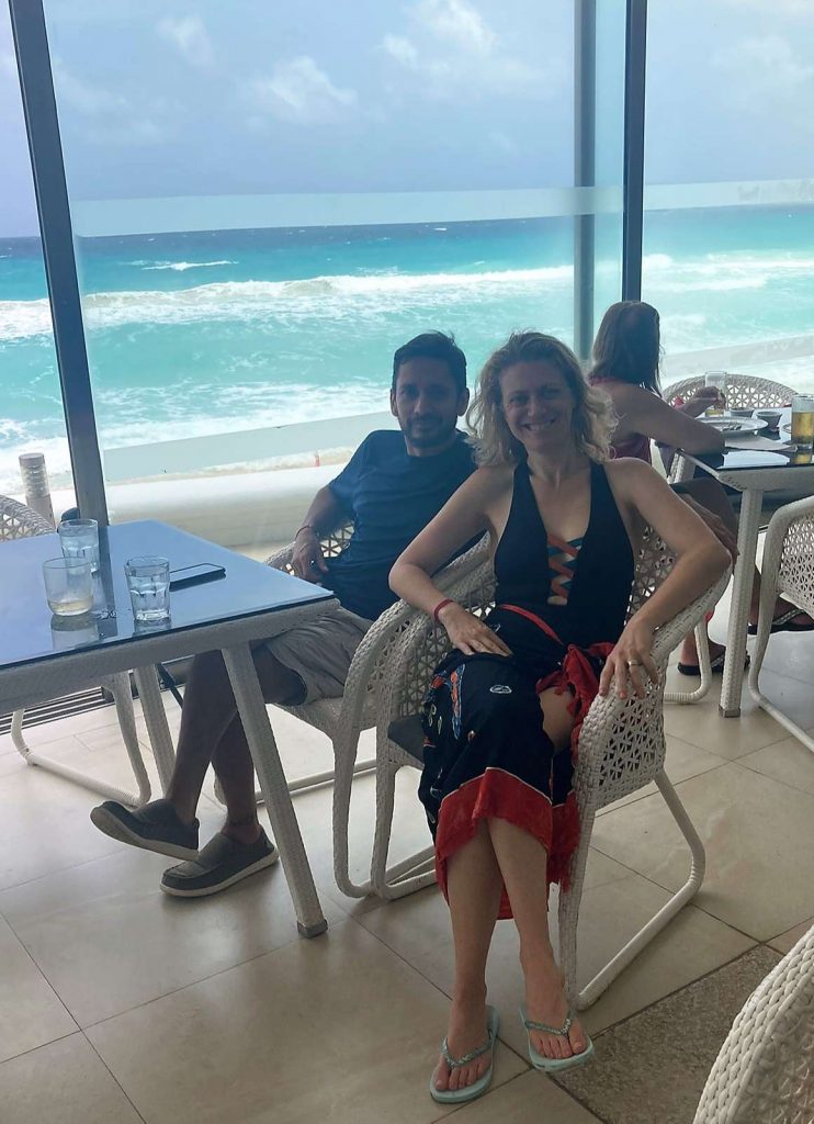 woman and man sitting in a near by the beach restaurant in cancun