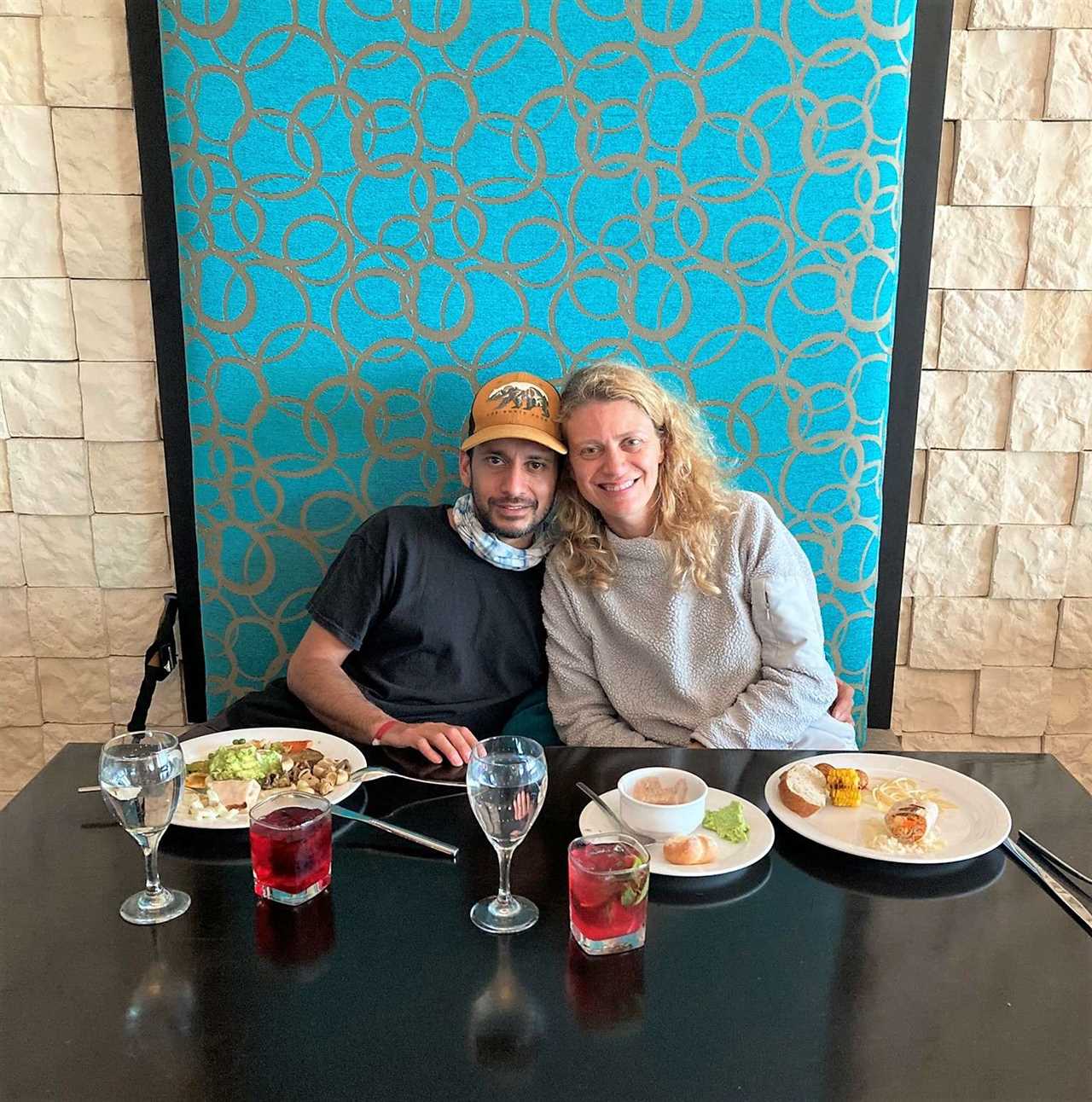 a couple sitting inside a bottomless brunf buffet restaurant