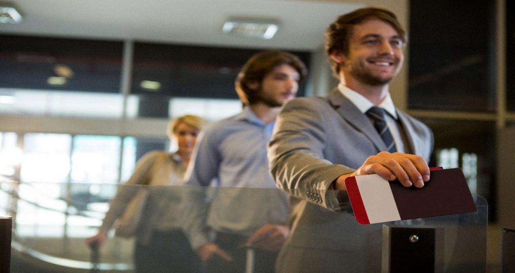 man holding passport in a line