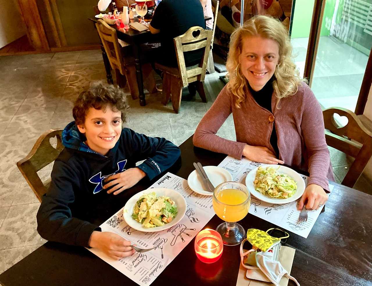 mom and son sitting on a table at kloster in guatemala