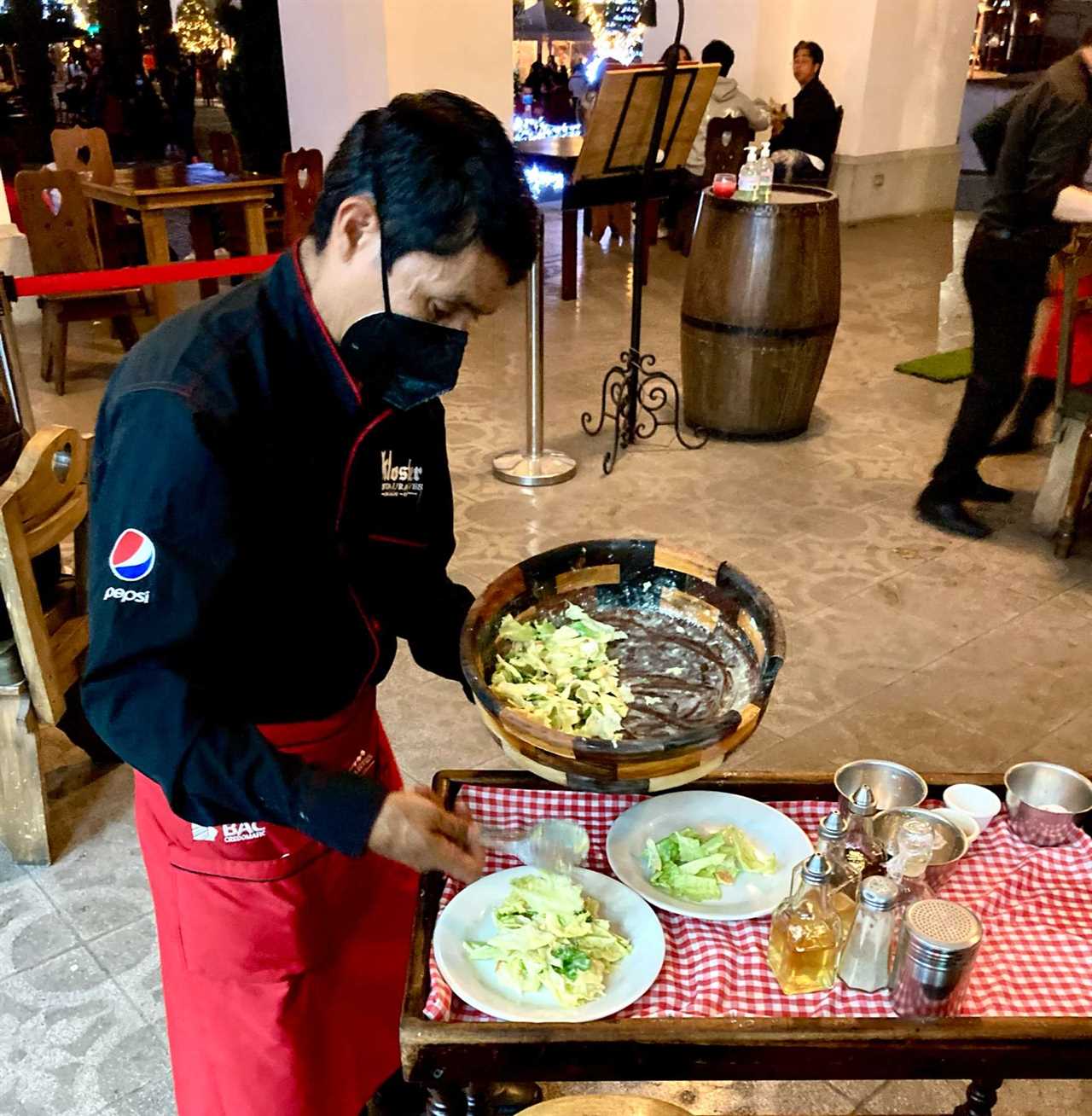 Man making a salad cesar at kloster restaurant in guatemala