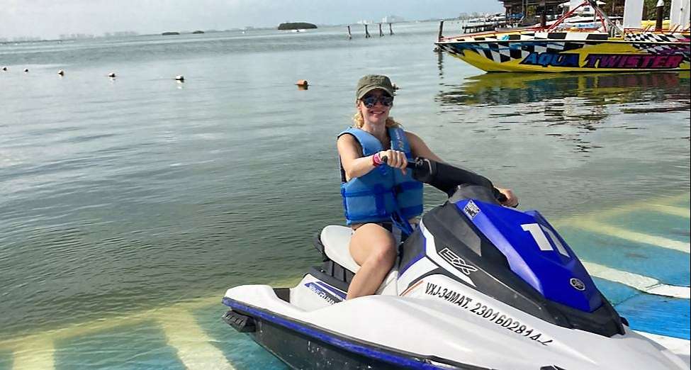 woman riding a wave runner in cancun