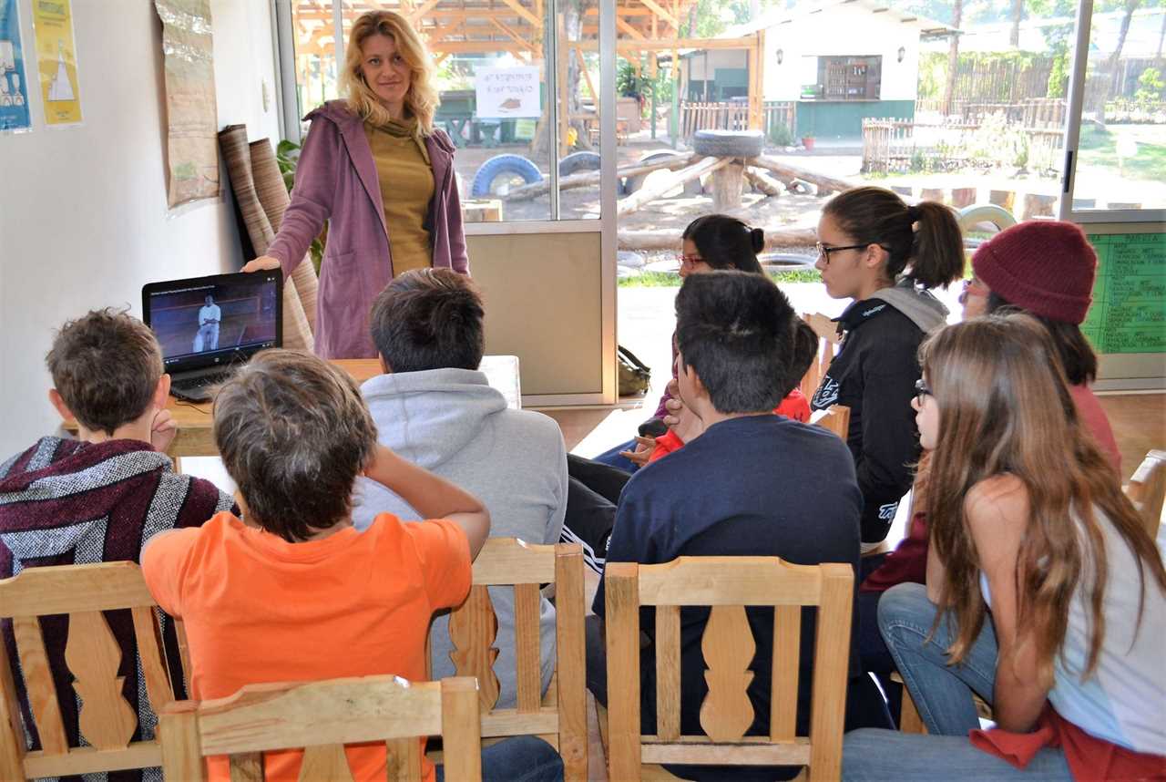 Woman showing a video to kids in a school in guatemala
