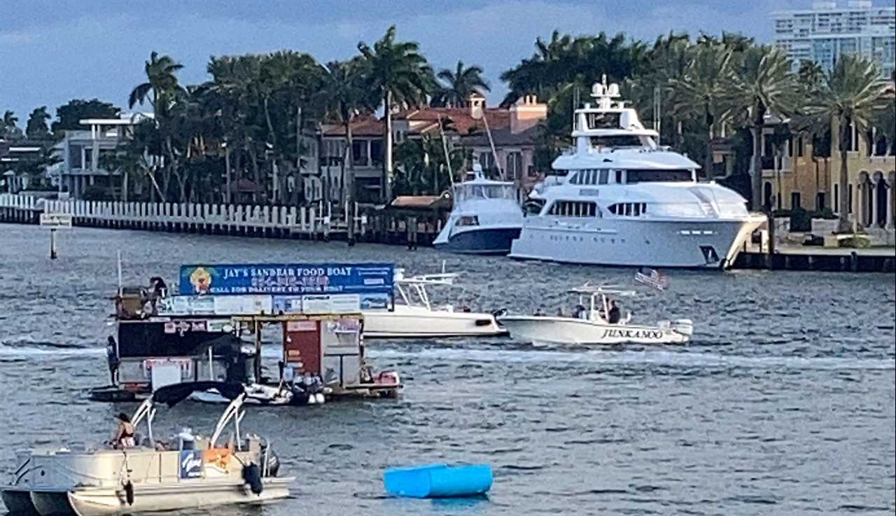 a yacht and some boats on fort lauderdale canals