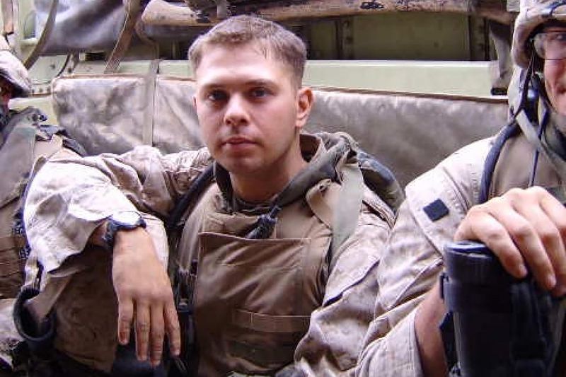 A young man in desert camouflage gear.