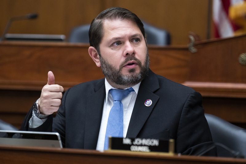 Rep. Ruben Gallego sitting in Congress and making a thumbs-up gesture.