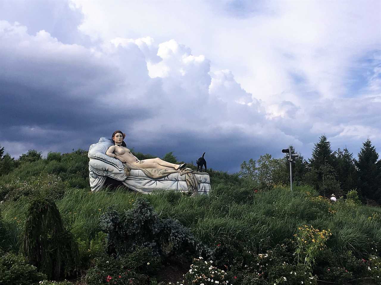 women laying in bet sculpture at garden of sculptures Family Fun