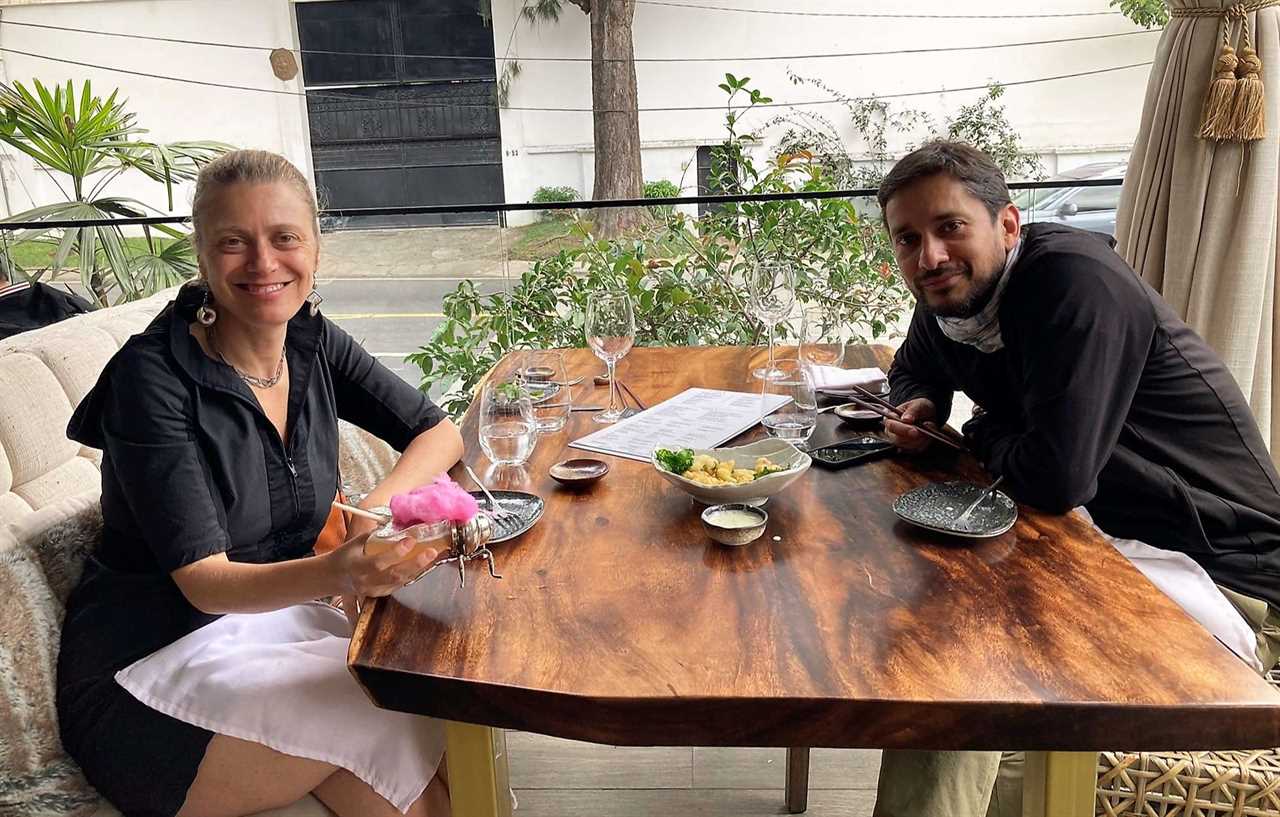 a couple sitting around a table at salvaje restaurante chain in guatemala