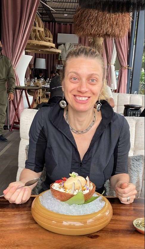 woman smiling happy with a dish at salvaje restaurant guatemala