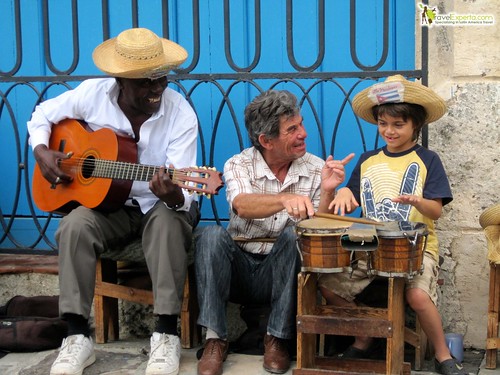 kid playing music with cubans in havana