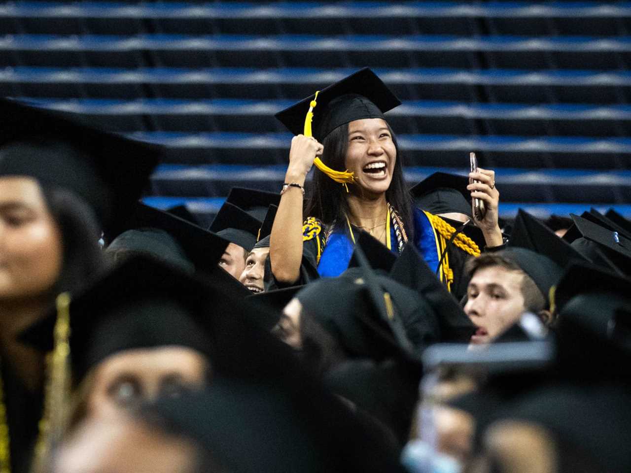 A crowd of people wearing graduation gowns and mortar boards.