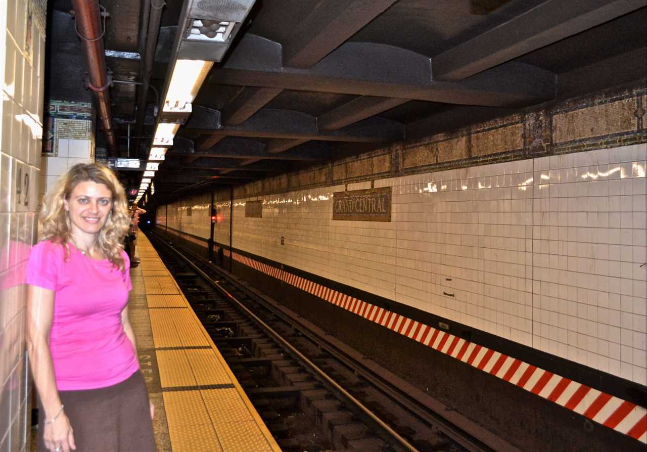 woman waiting for a train in nyc subway