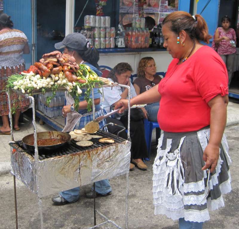 woman cooking popular guatmalan street food