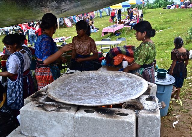 Guatemalan street food vendors making tortillas