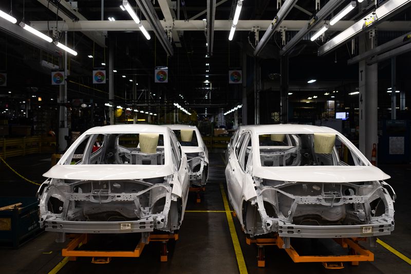 Four car bodies on an assembly line awaiting interior fixtures.