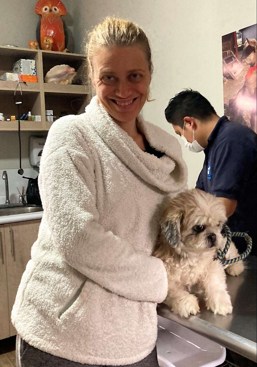 woman holding a dog for microchip