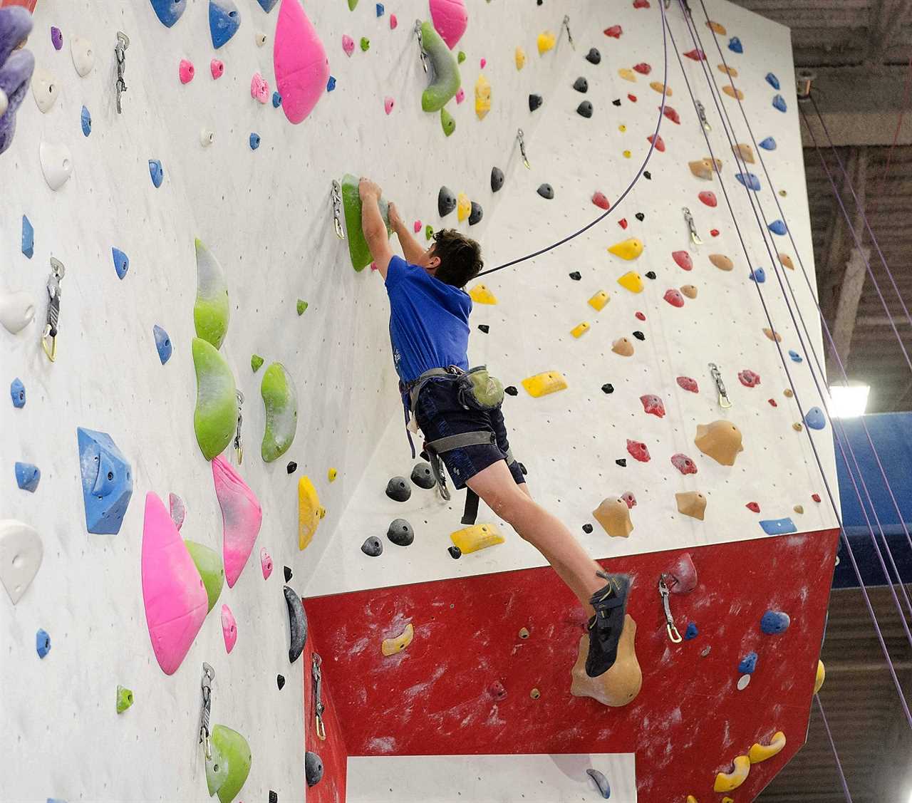 teen climbing in a indoor gym