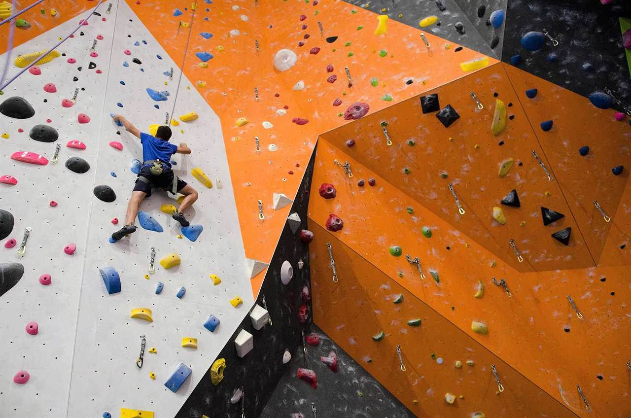 teen climbing at a indoor climbing gym