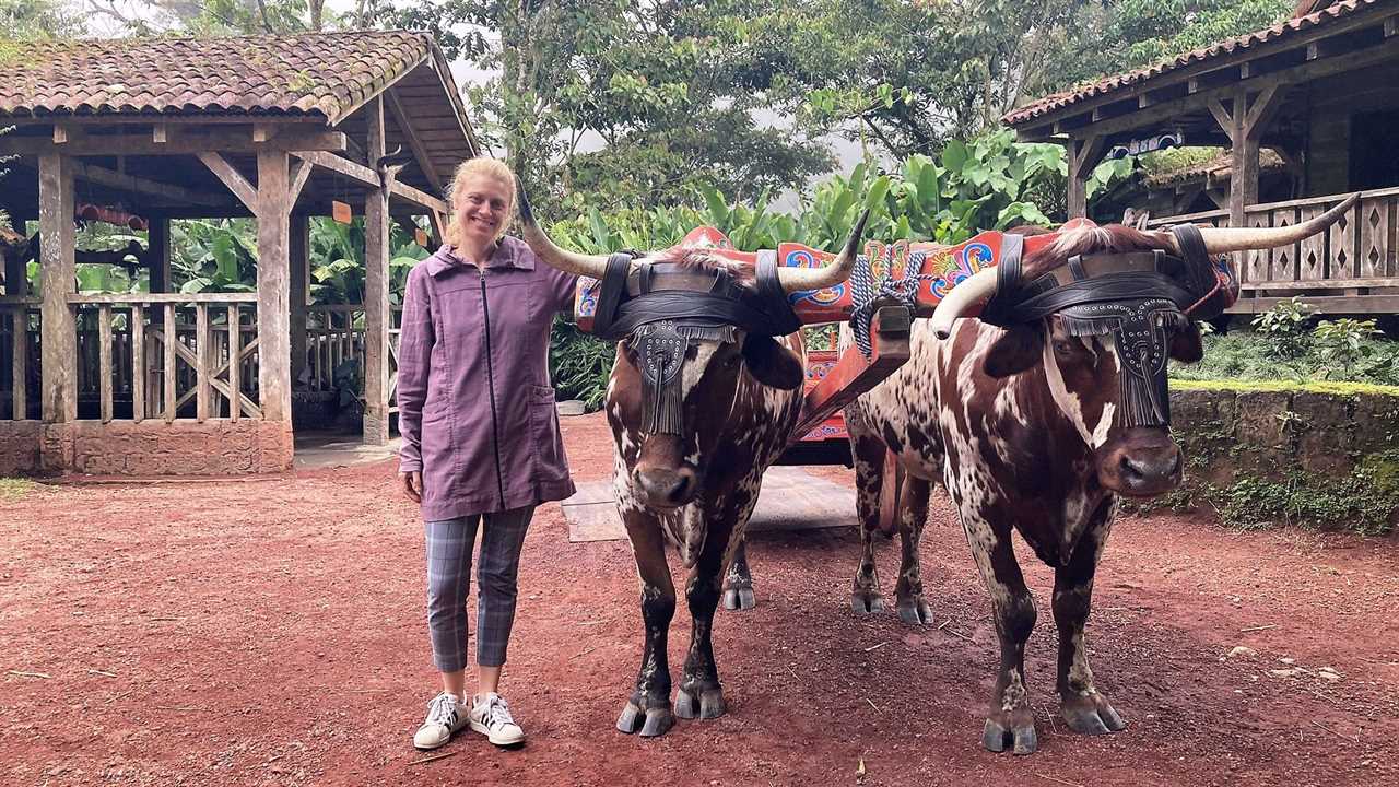 woman standing next to a bull la paz peace lodge