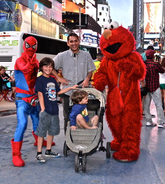 Spiderman, Elmo and the family having fun at times Square