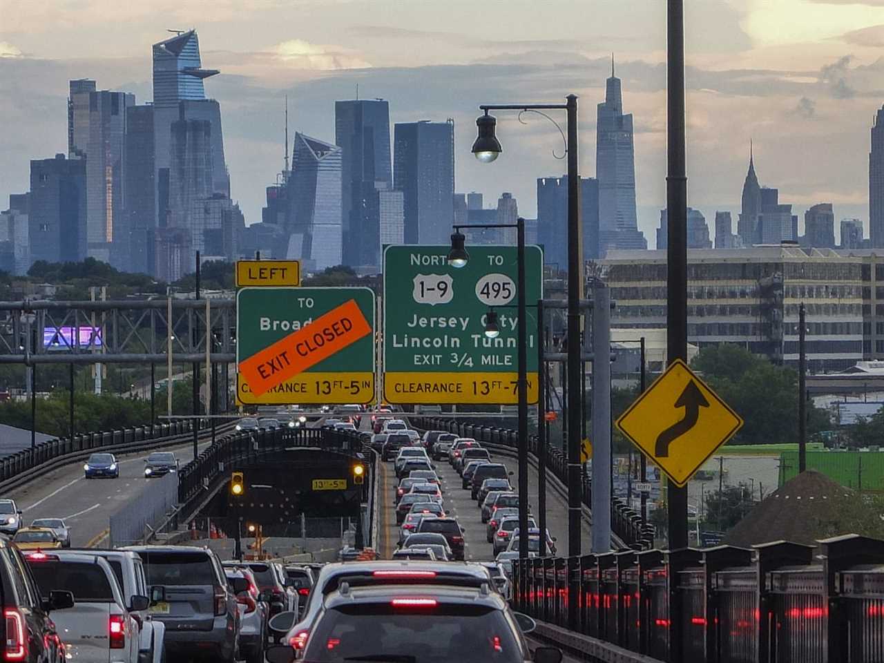 The Empire State Building and tourist district skyline are seen from a traffic jam along the route to New York City on August 17, 2022, in Jersey City, New Jersey.