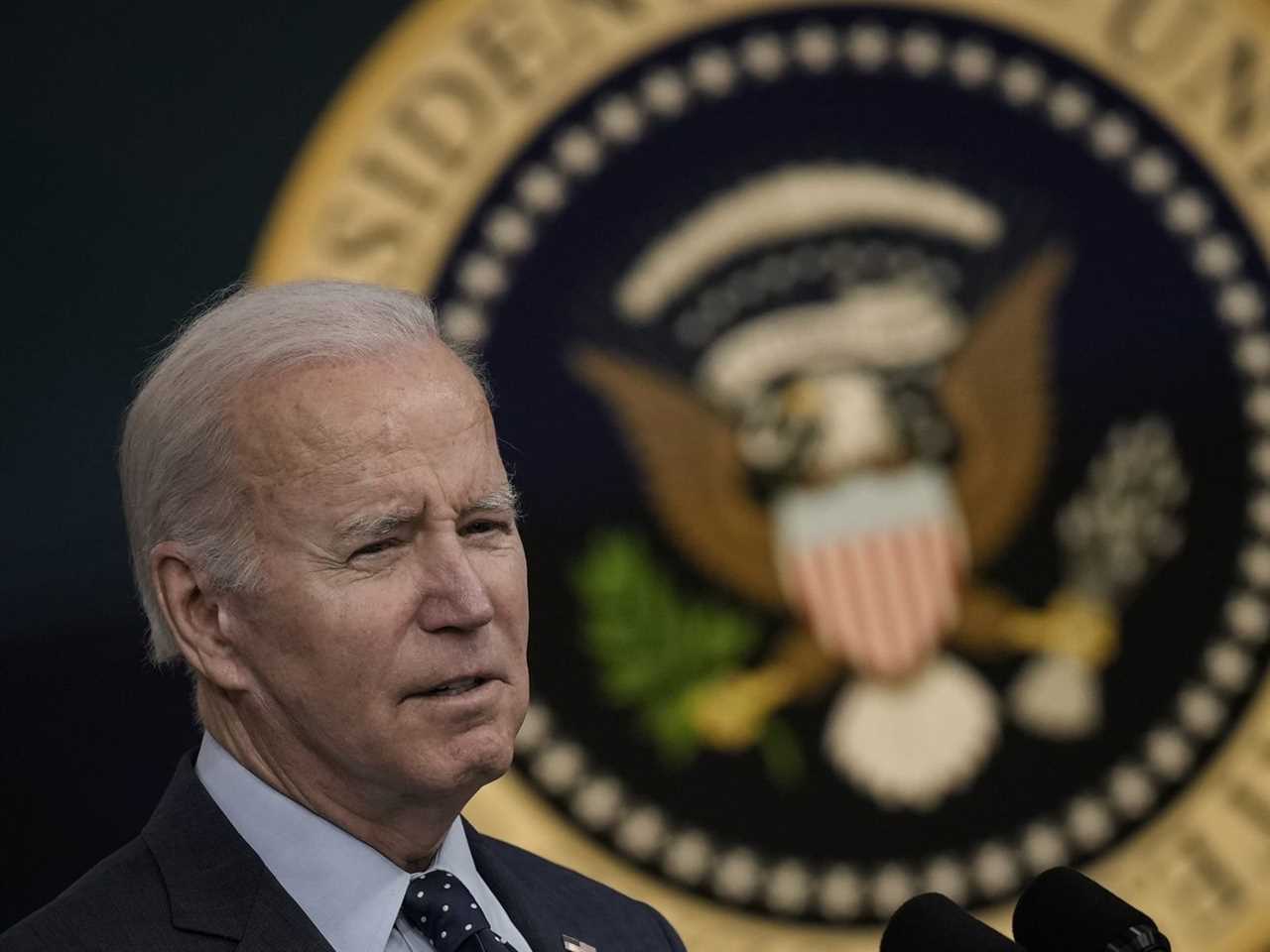 President Joe Biden with the presidential seal behind him.