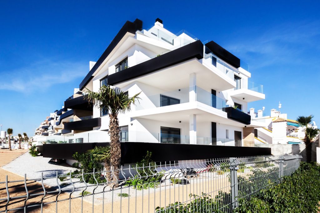 luxury villa surrounded by plants near a beach