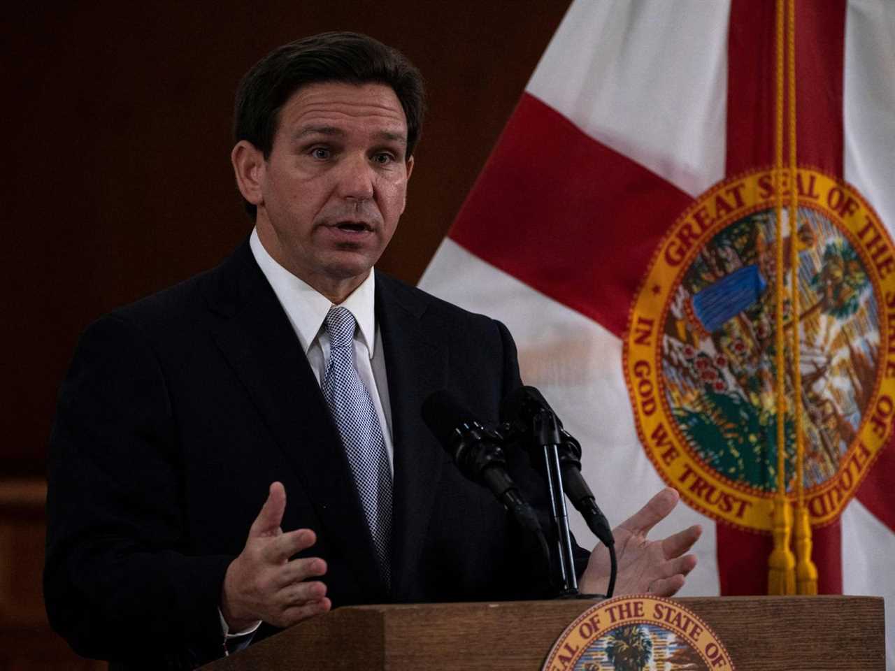 DeSantis stands at a lectern.