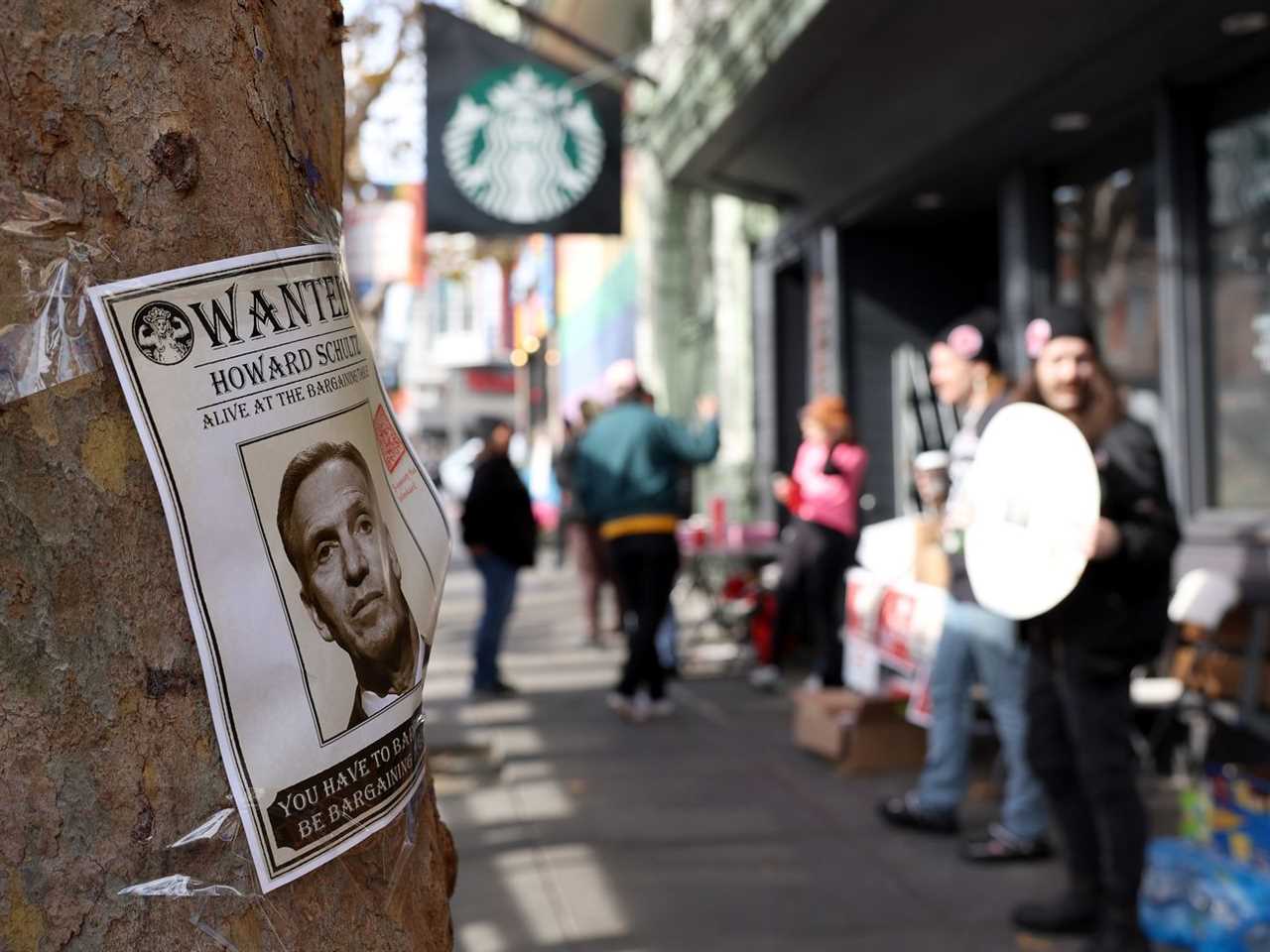 A photo of Starbucks interim CEO Howard Schultz is posted on a tree as striking Starbucks workers picket outside of a Starbucks coffee shop during a national strike on November 17, 2022 in San Francisco, California.