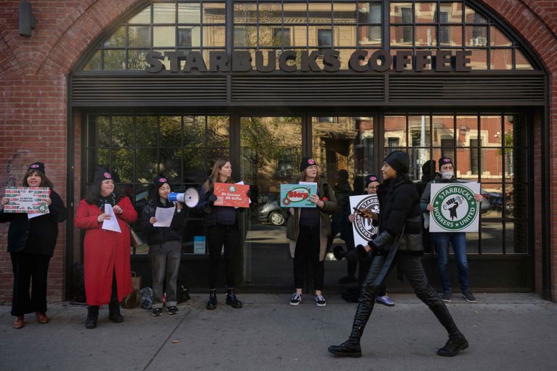 Starbucks workers strike outside a Starbucks coffee shop on November 17, 2022 in Brooklyn.