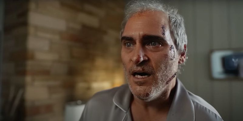 Joaquin Phoenix, his head pretty beat up now, looks terrified.