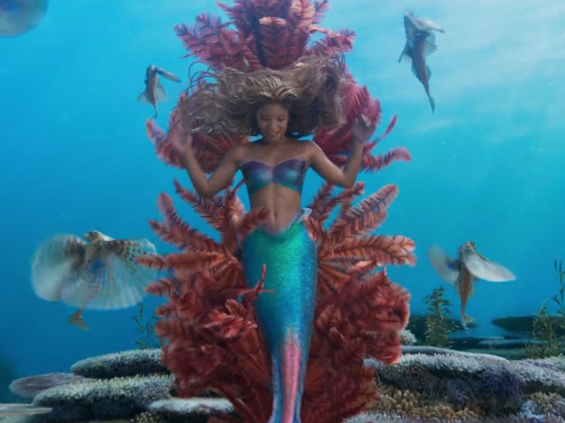 An image of Halle Bailey as a mermaid, under the sea.