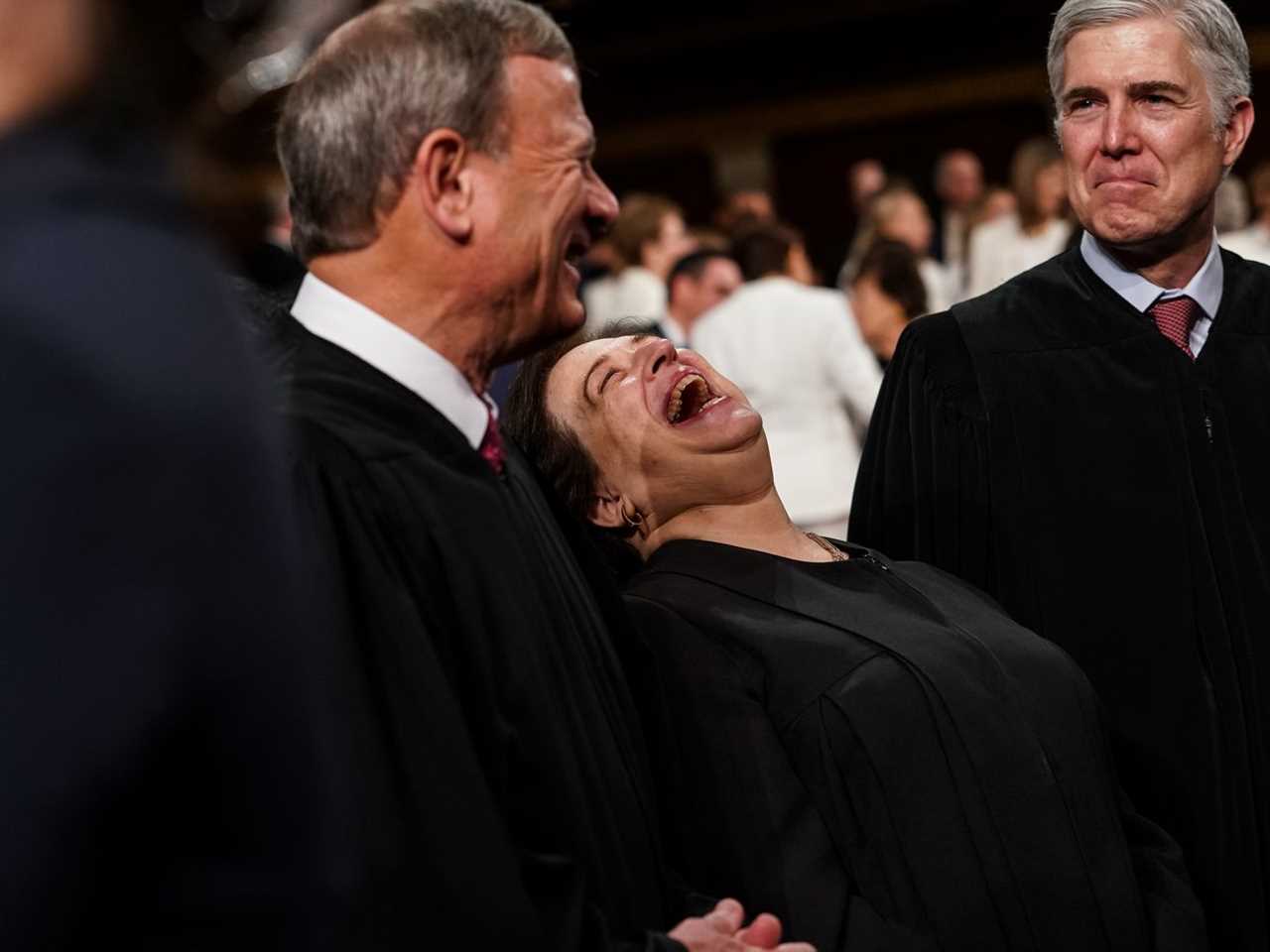 John Roberts, Elena Kagan, and Neil Gorsuch talk together. Kagan is laughing.