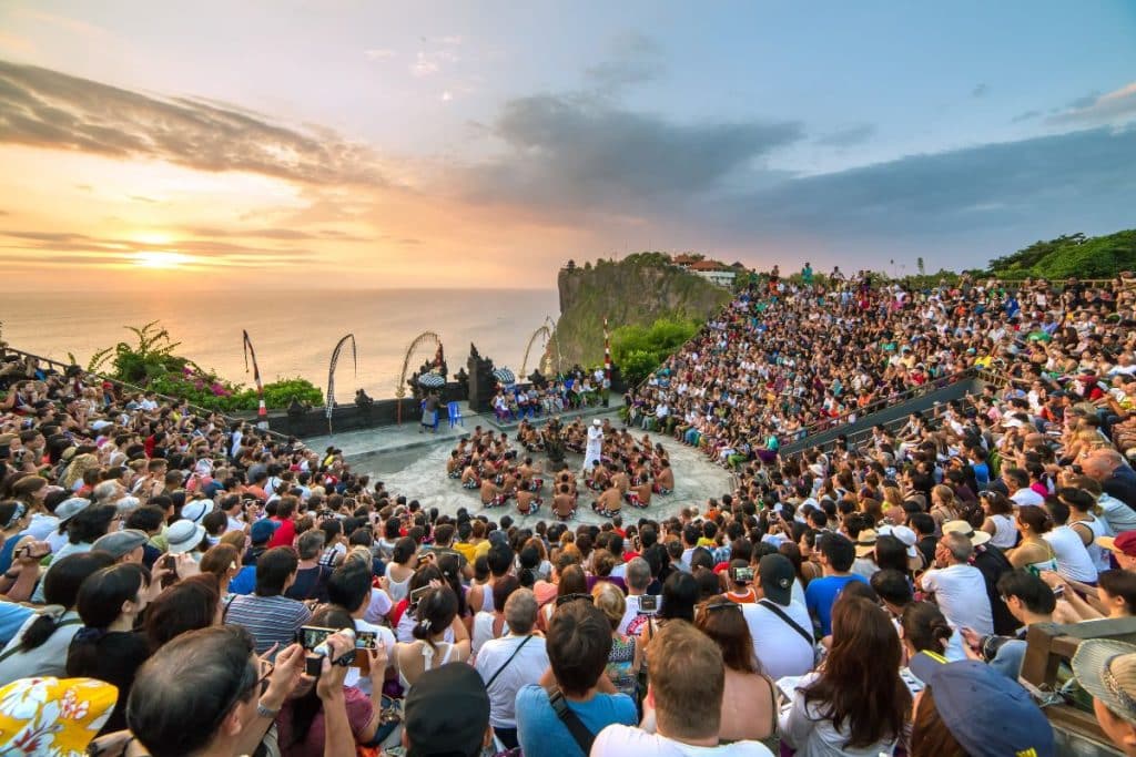 crowd of tourists watching bali's celebration 