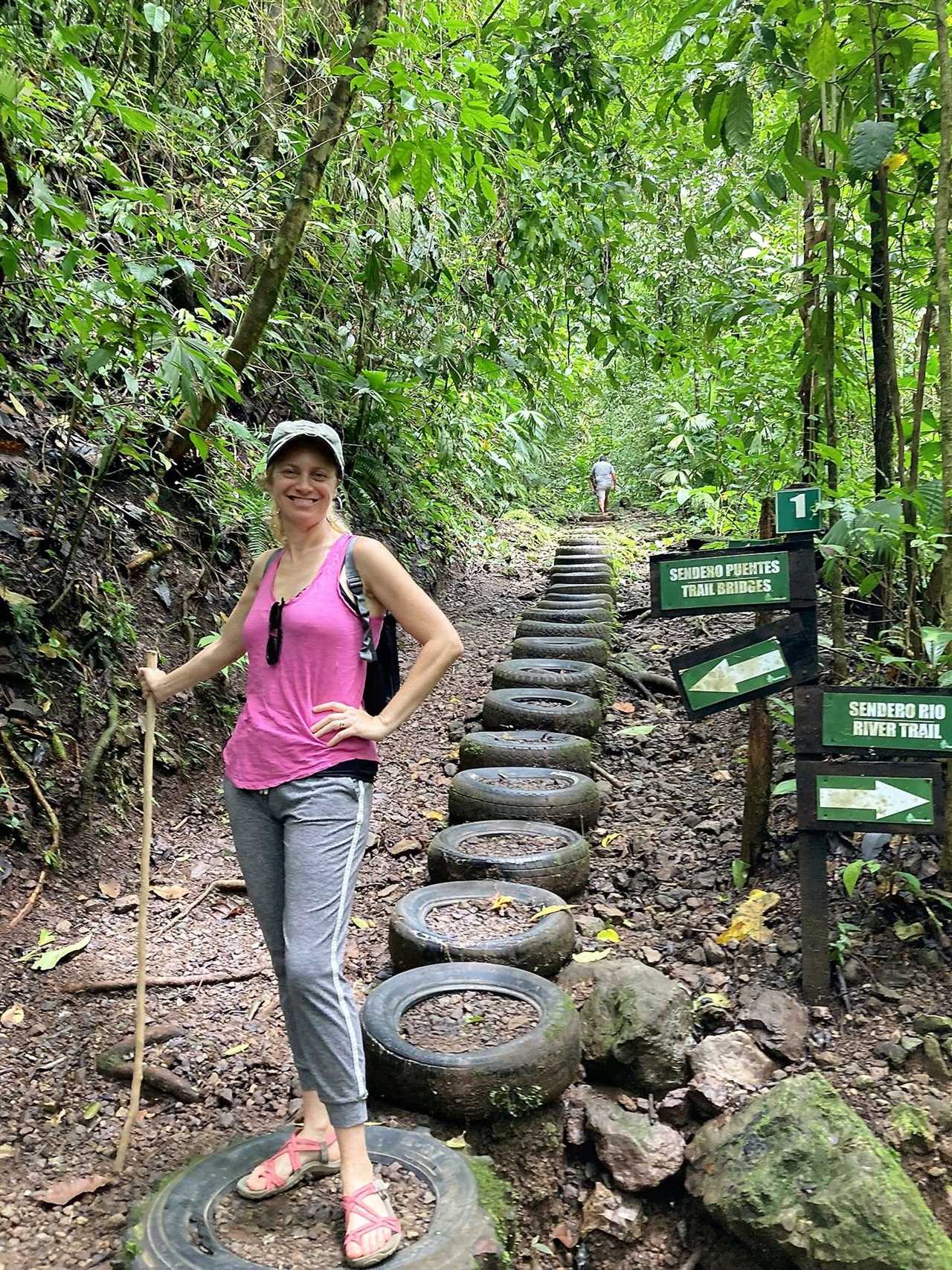 woman on a trail in rainmaker biological reserve costa rica